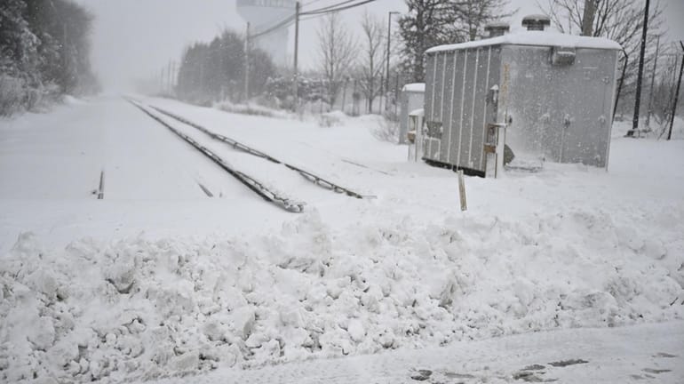 Plowed snow blocks LIRR tracks at South Oyster Bay Road in...