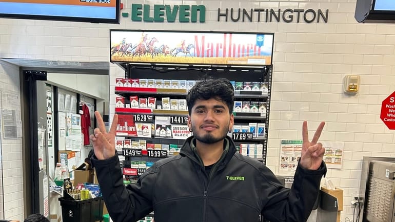 Aryan Paul poses for a photo as he works at...