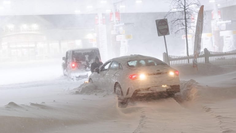 A motorist gets stuck attempting to enter a gas station...