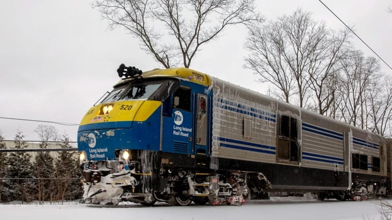 An ice-covered LIRR train travels on the Port Jefferson branch...