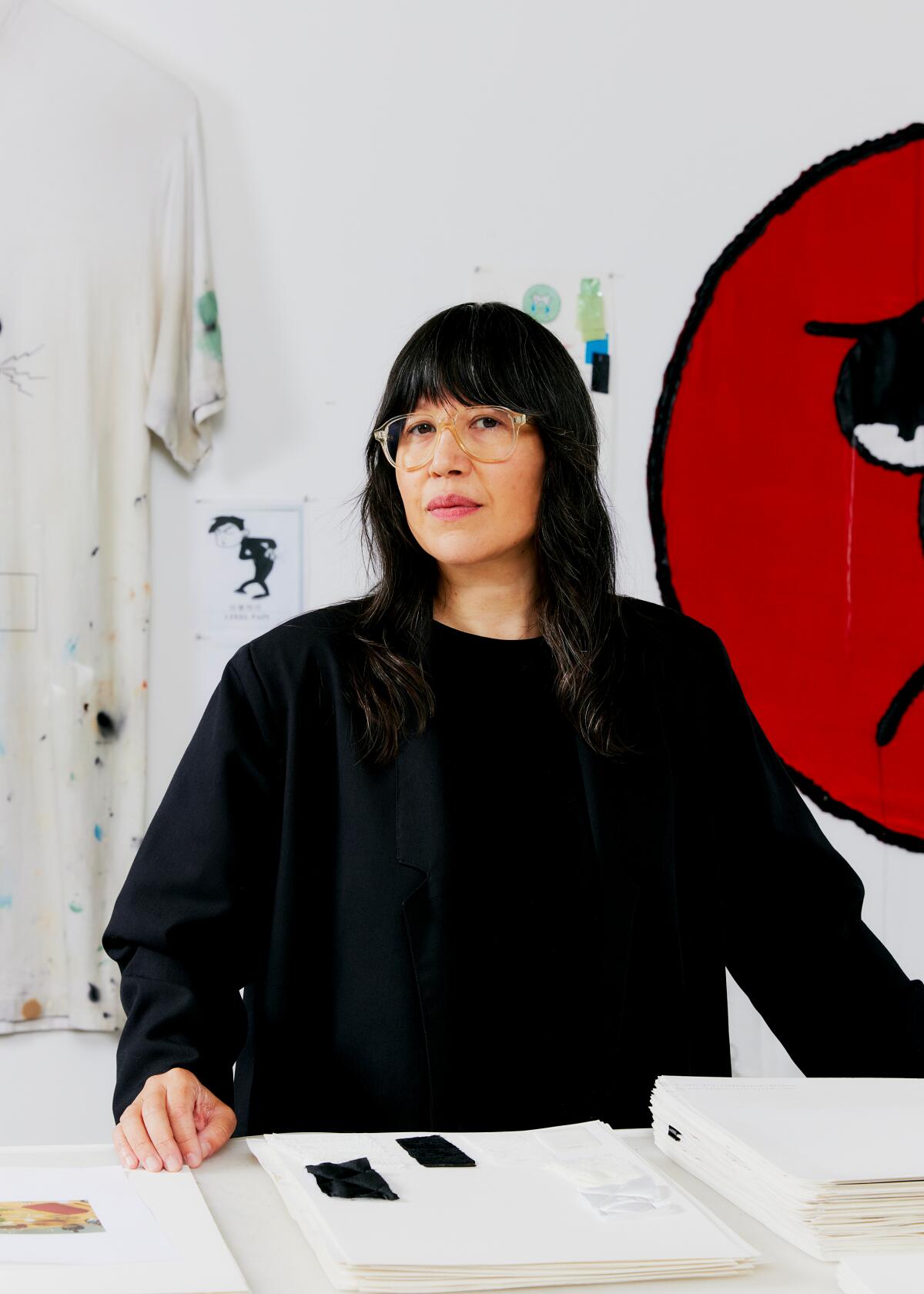 A woman in front of a piece of art.