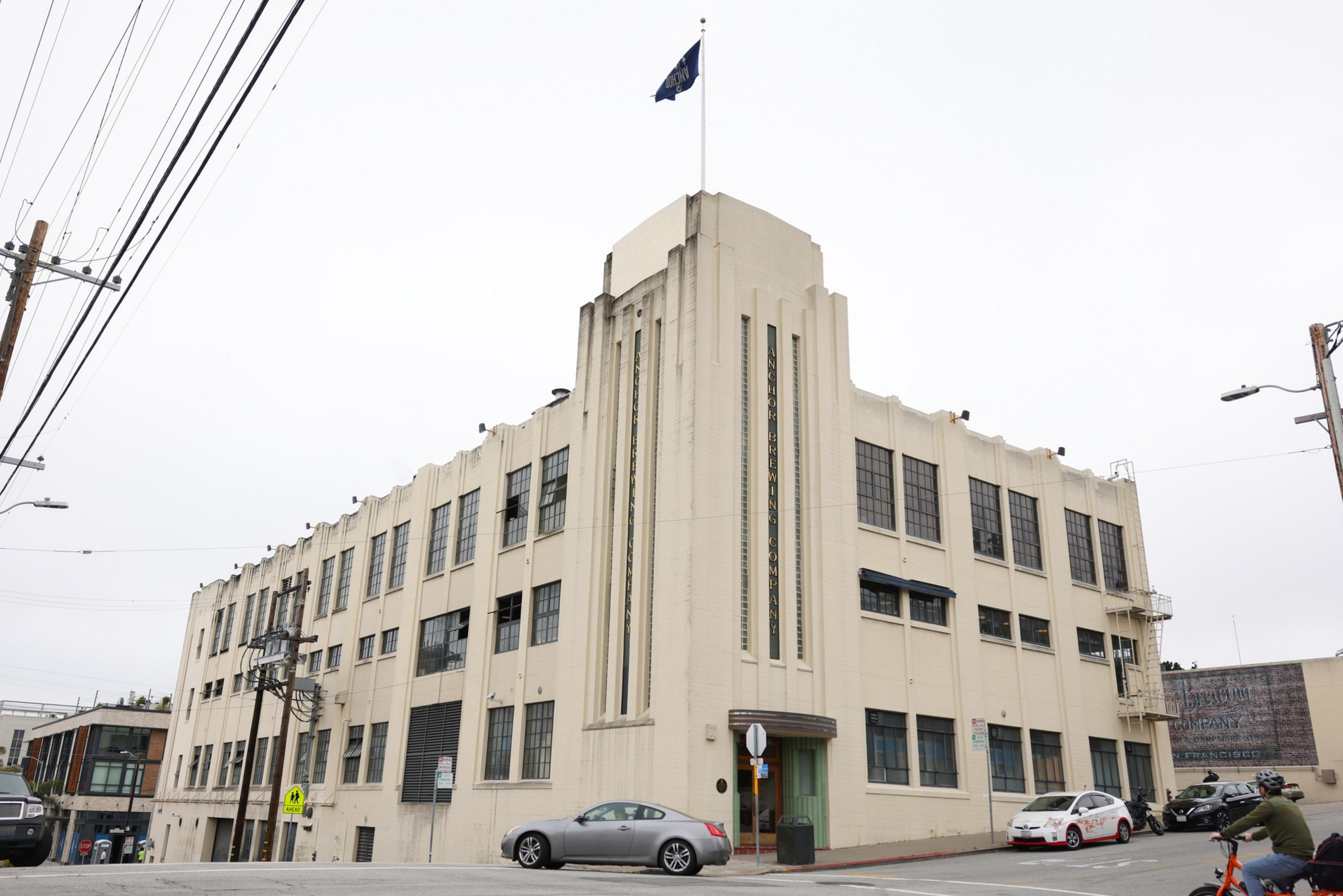 a pale Art Deco brewery is seen from below
