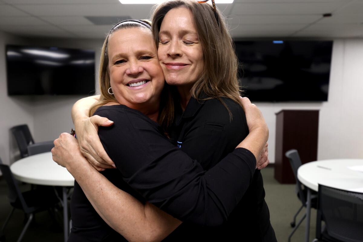 Cory Moss and Kate Movius hug