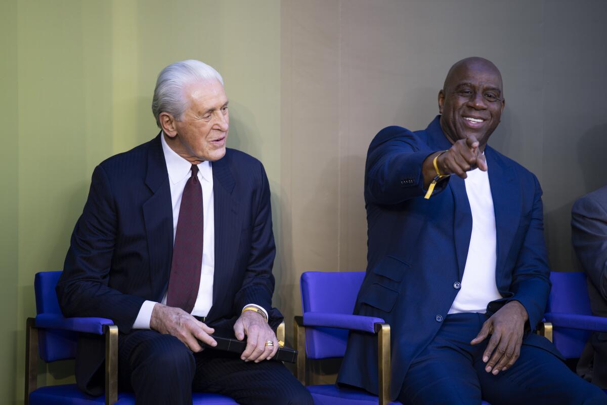 Magic Johnson with Pat Riley at the unveiling of the statue of Riley.