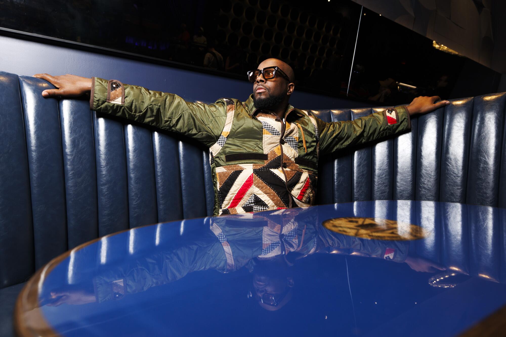 Wyclef Jean sits in a booth at Blue Note LA