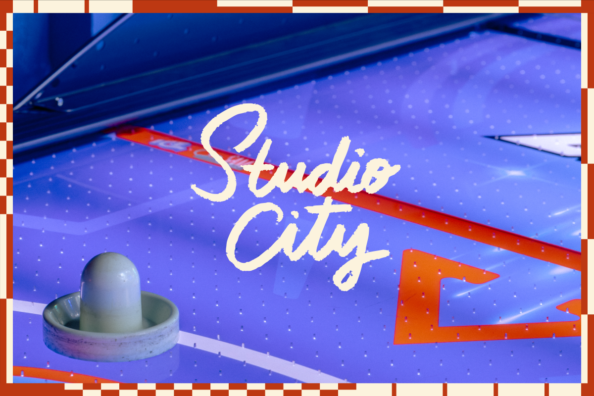 Air hockey table close-up with the words "Studio City" in script centered on top