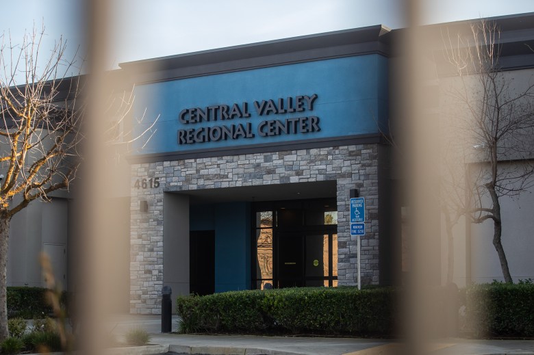 The entrance of a dark beige building with a blue sign that reads "Central Valley Regional Center" on the top.