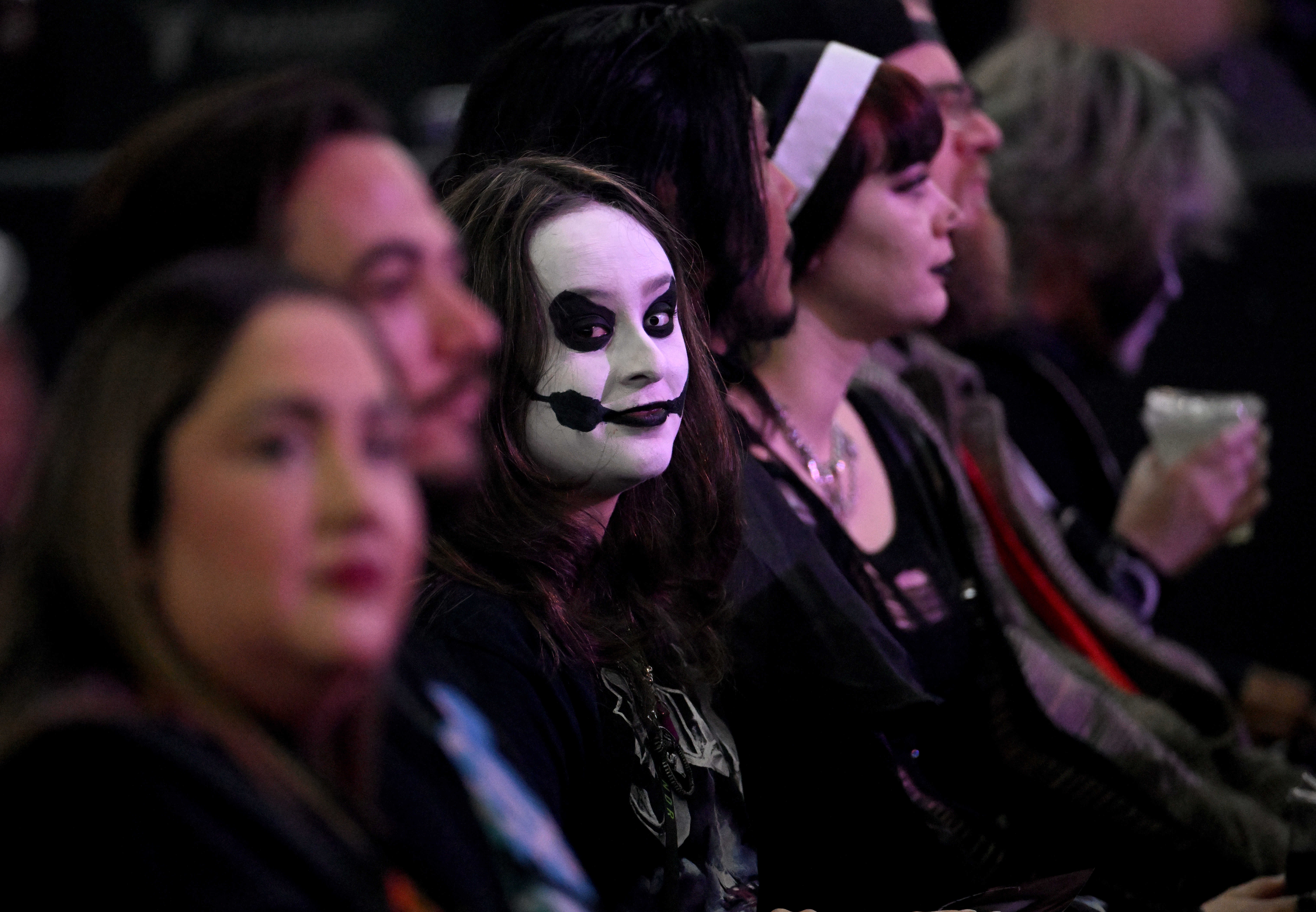 Fans of the Swedish rock band Ghost dress up and...