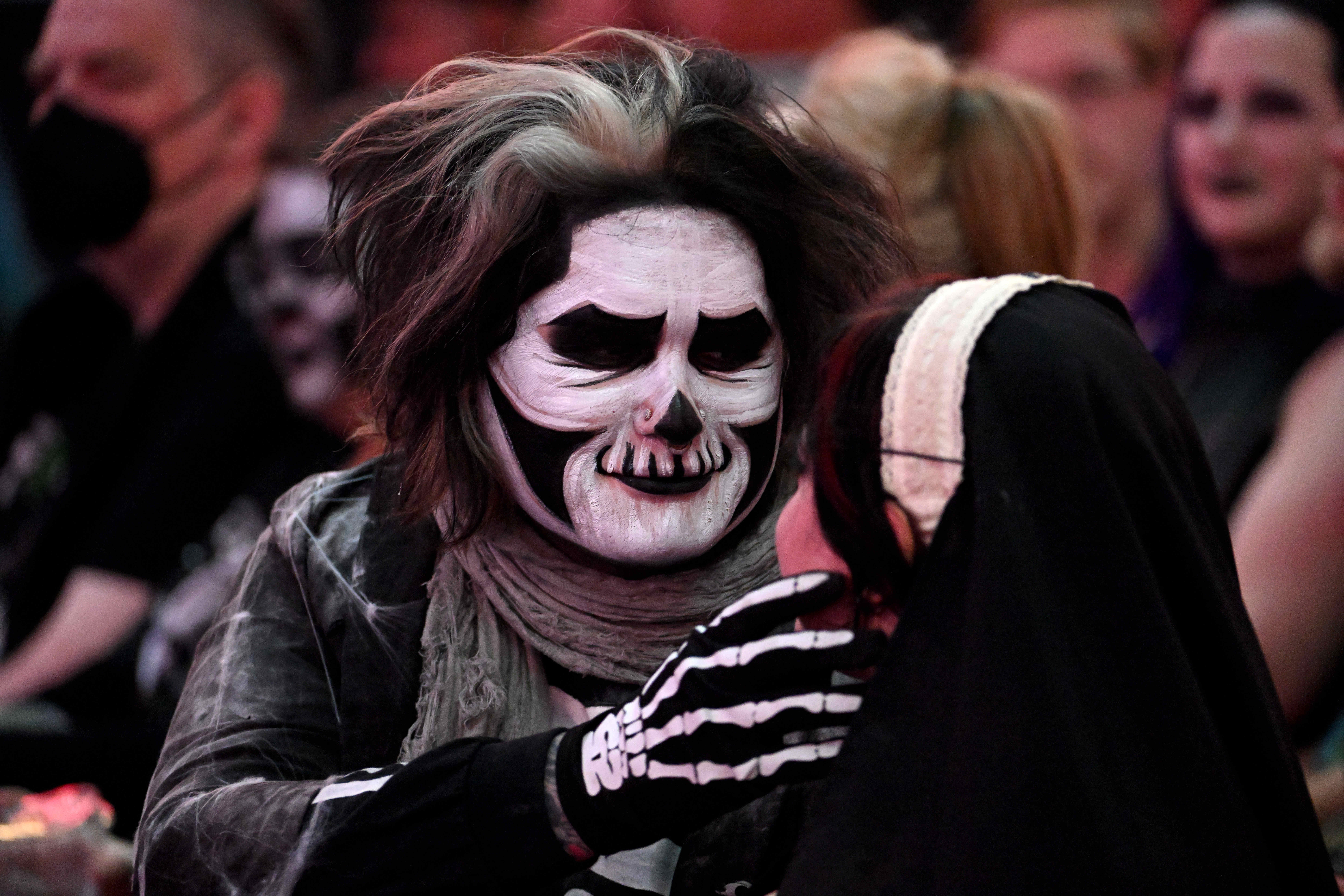 Fans of the Swedish rock band Ghost dress up and...