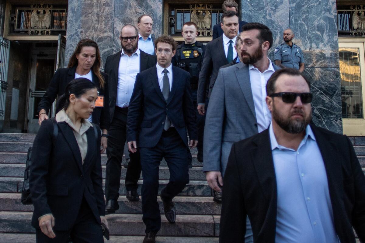 A group of people leave Los Angeles Superior Court.