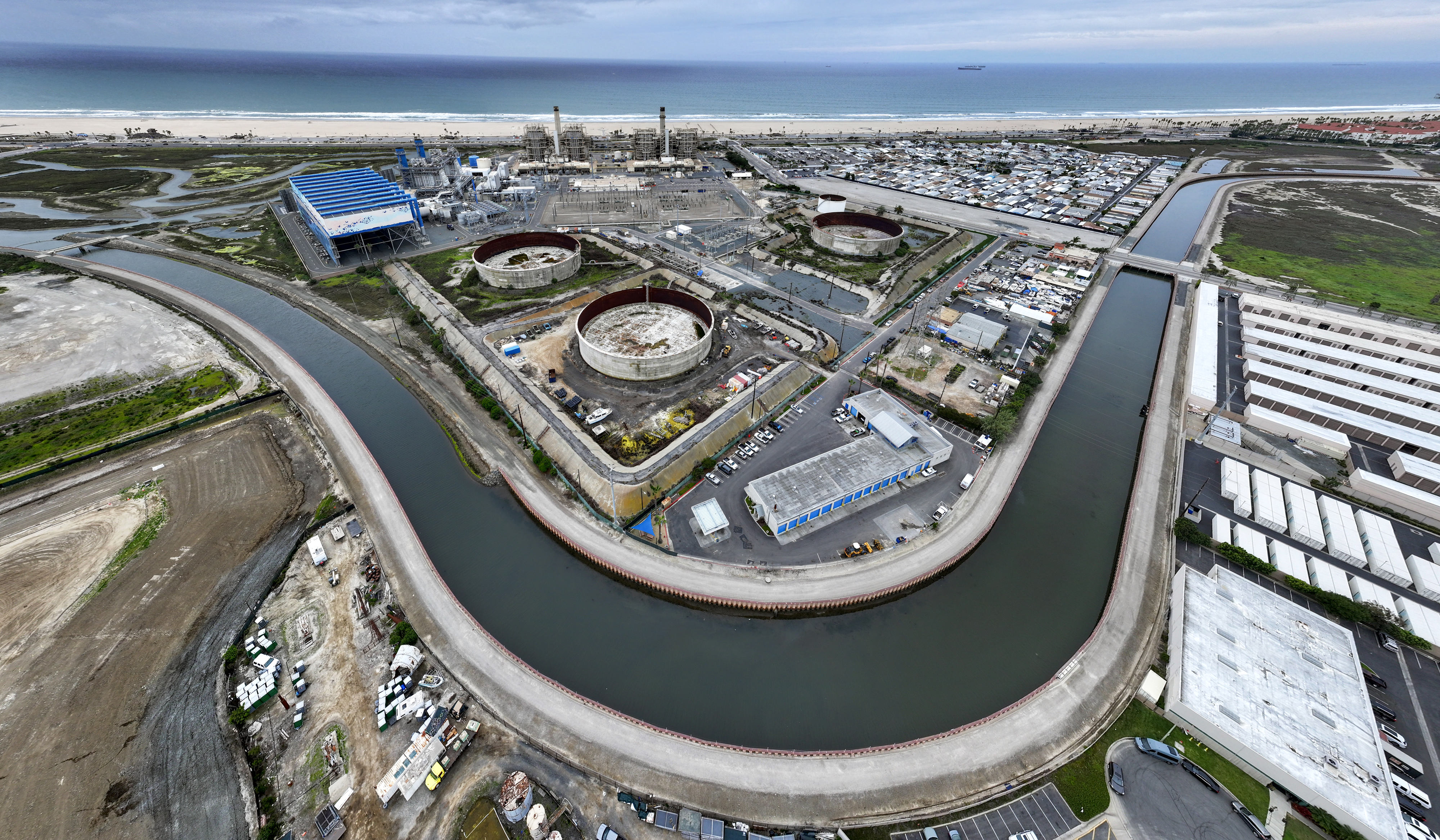 Tanks sit between the AES Huntington Beach power plant and...