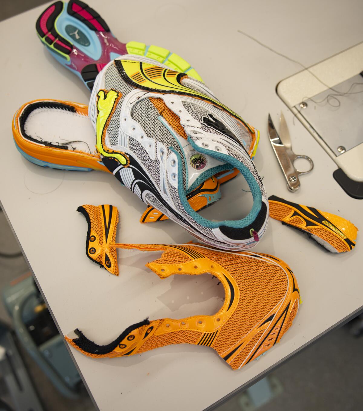 Pieces of a shoe sit on a workbench in the Puma Studio L.A.