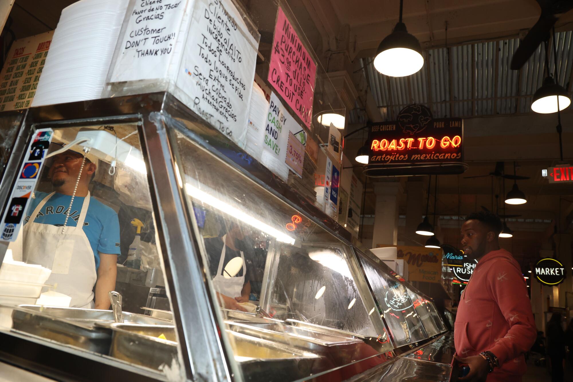 Customer Andre Merritt, right, orders from Roast to Go in 2024.