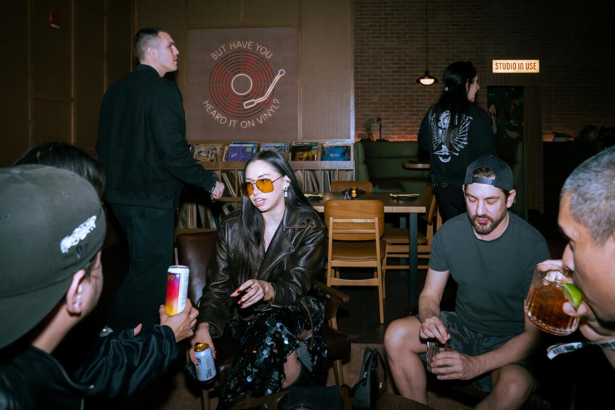 Patrons at a bar with vinyl records.