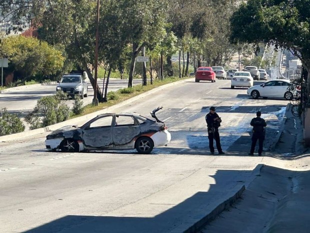 A taxi burns on Avenida Internacional on Feb. 22. There were no injuries. (Yolanda Morales)