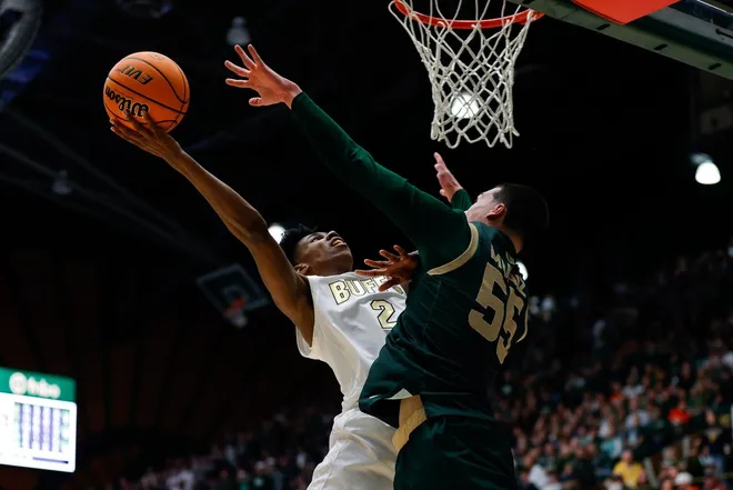Dec 6, 2025; Fort Collins, Colorado, USA; Colorado Buffaloes guard Isaiah Johnson (2) drives to the net against Colorado State Rams forward Jevin Muniz (55) in the second half at Moby Arena.