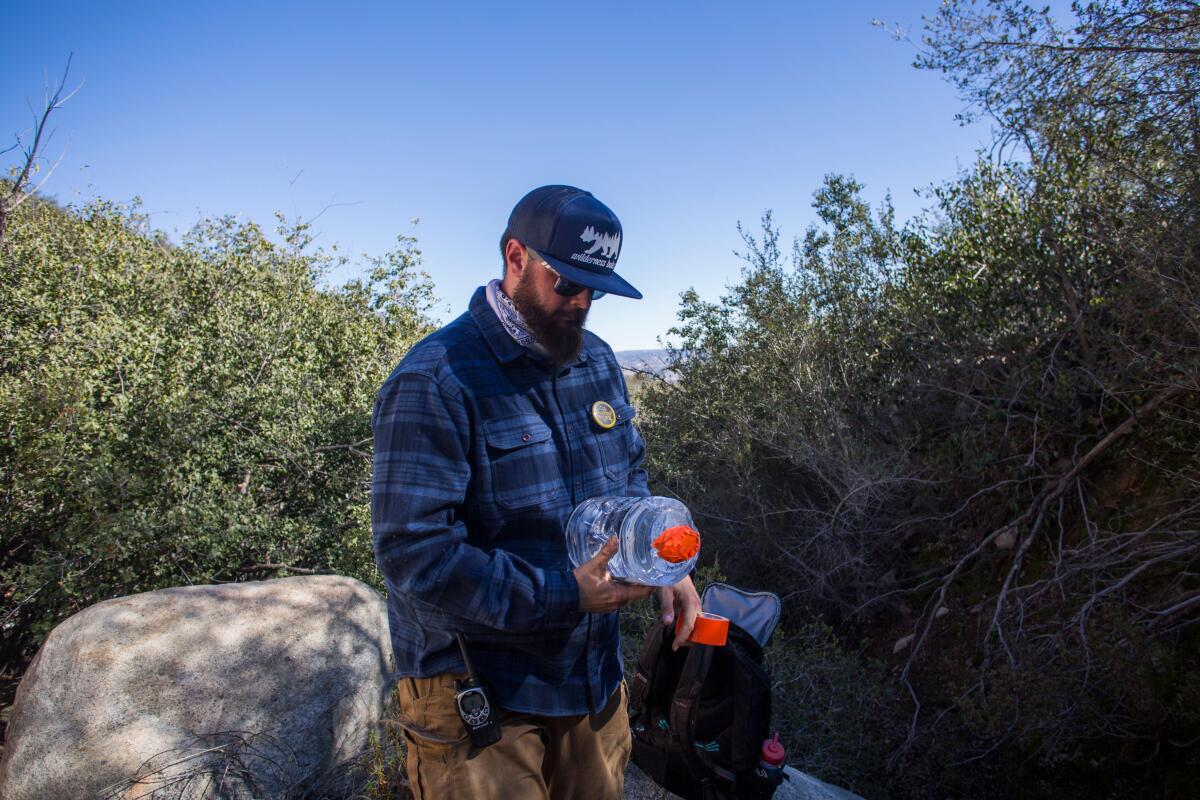 Volunteer of the nonprofit Border Angels James Cordero is in a remote area of the mountains.