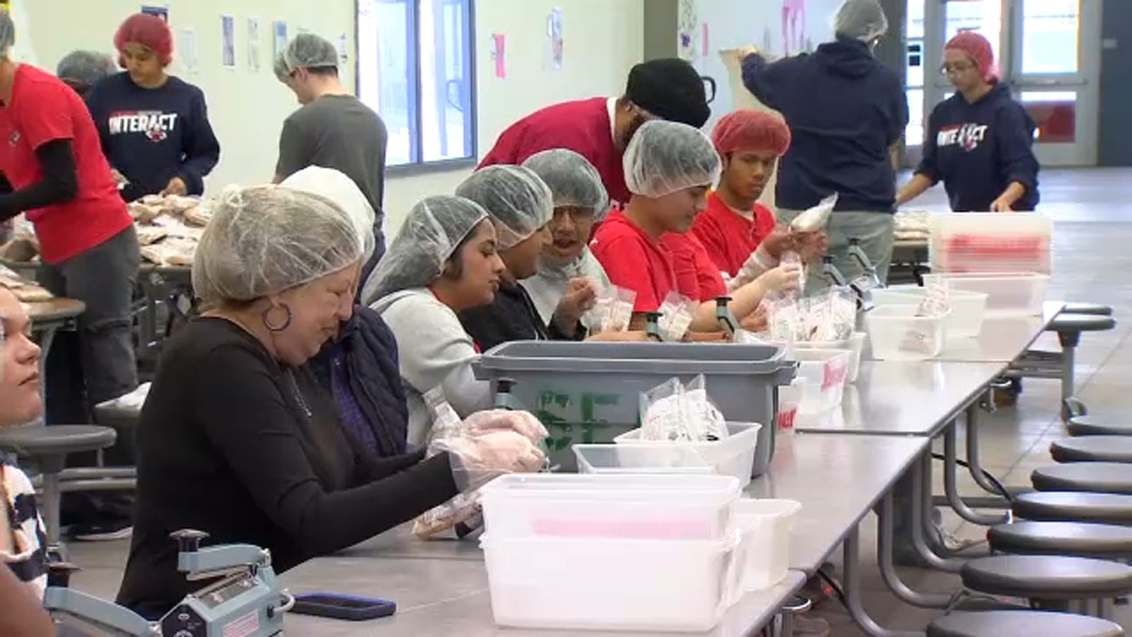 Local students assemble meals to be sent to Southeast Asia