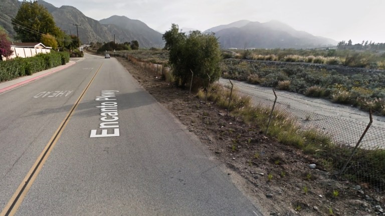 Encanto Parkway in Azusa with a drainage ditch beside it.