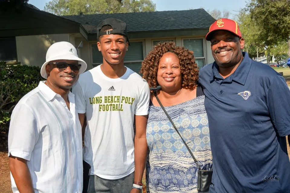 Alex Austin, second left, and his father Al Austin, left. Facebook/Councilmember Al Austin II