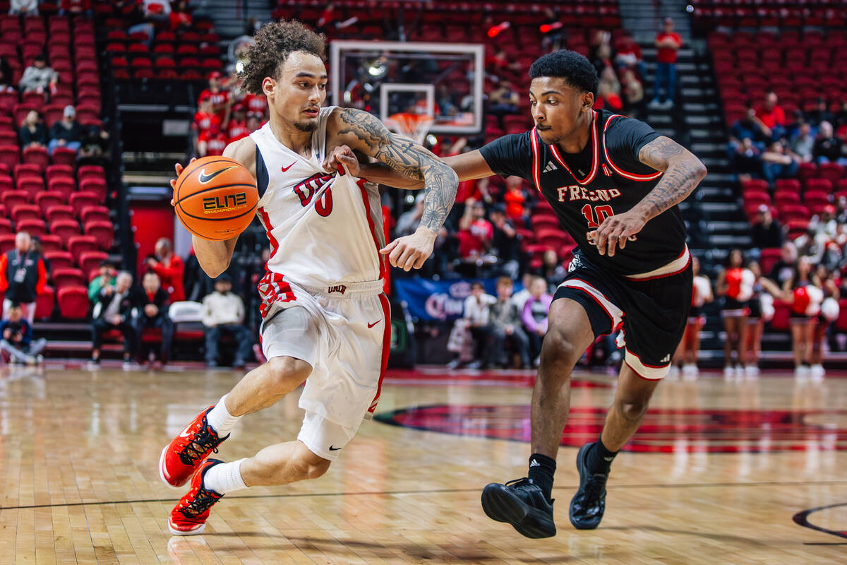 UNLV guard Dravyn Gibbs-Lawhorn (0) dribbles the ball as Fresno State guard Zaon Collins (10) g ...
