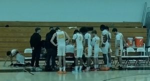 Coach Rob Hoyt instructs team during a time out - photo by Jason Banks