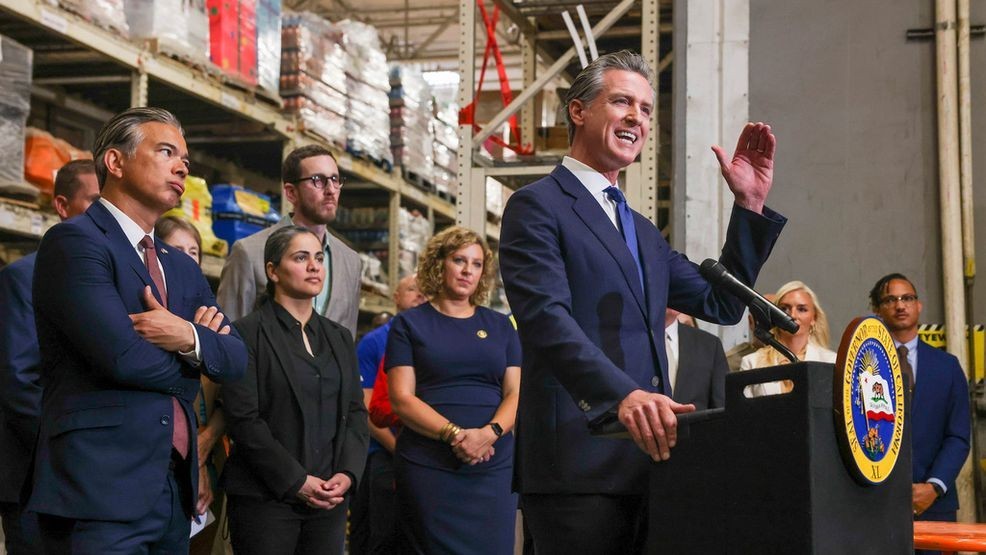 FILE - California Gov. Gavin Newsom speaks as Attorney General Bob Bonta, second from left, looks on after signing a bipartisan package of bills to combat retail crime during a press conference with state and local officials at Home Depot in San Jose, Calif., on Friday, Aug. 16, 2024. (Ray Chavez/Bay Area News Group via AP, File)