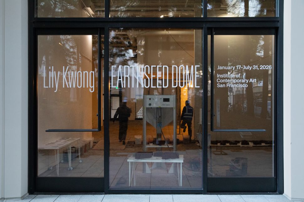Partially constructed earthen dome by Lily Kwong in Redwood Park, framed by surrounding trees and modern office buildings.