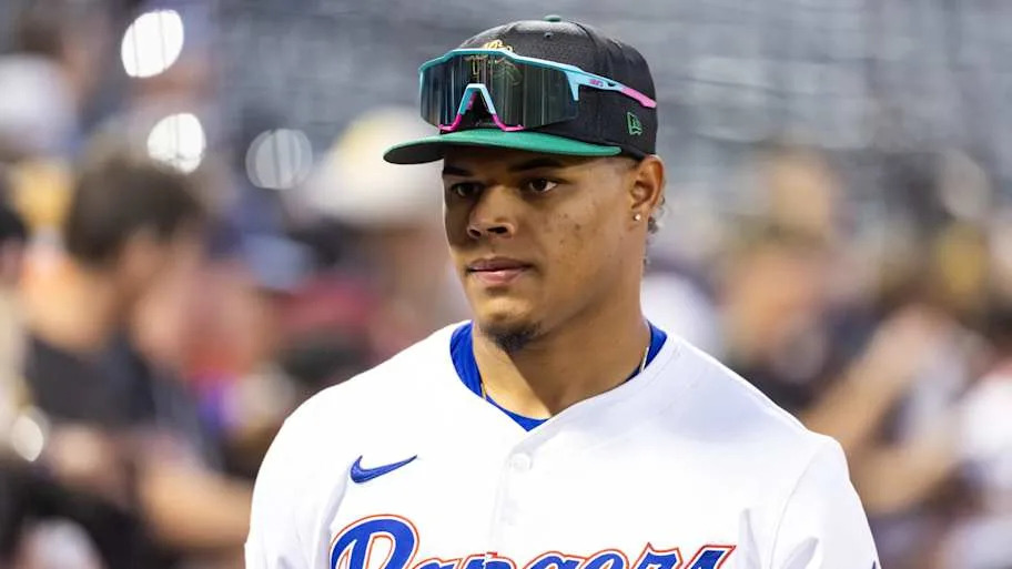 Texas Rangers pitcher Winston Santos looks on from a distance as a game is being played