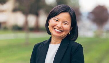 Ms. Kimura-Walsh smiles for a photo wearing a white blouse and black jacket.