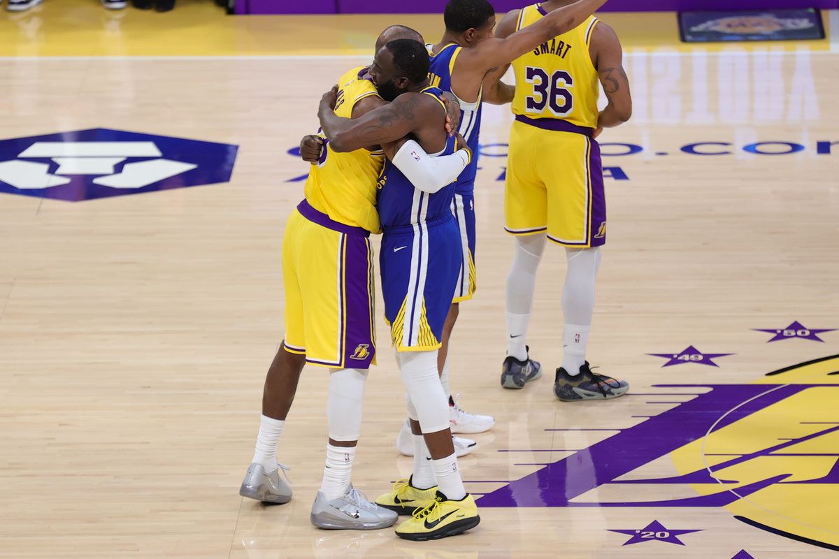 Los Angeles Lakers forward LeBron James (23) and Golden State Warriors forward Draymond Green (23) embrace each other before an NBA game on February 7, 2025 in Los Angeles, CA.