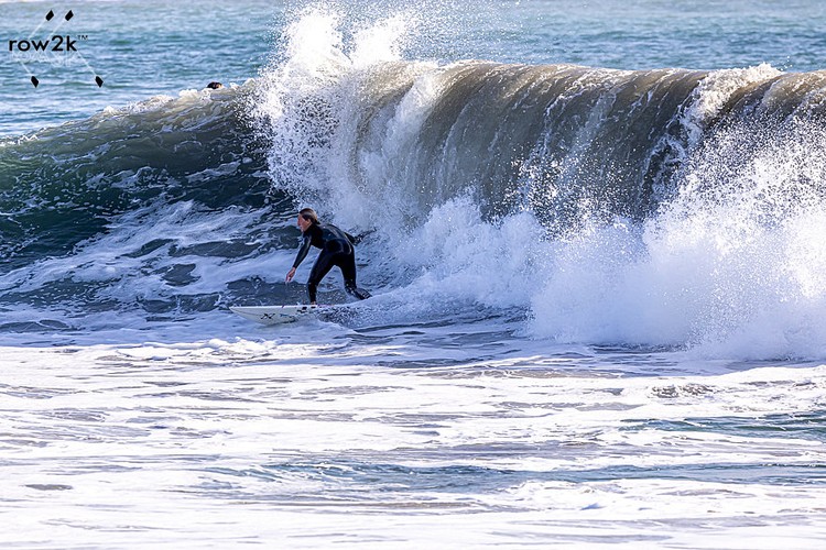 Surfer on the southeast side of Seal Beach Pier