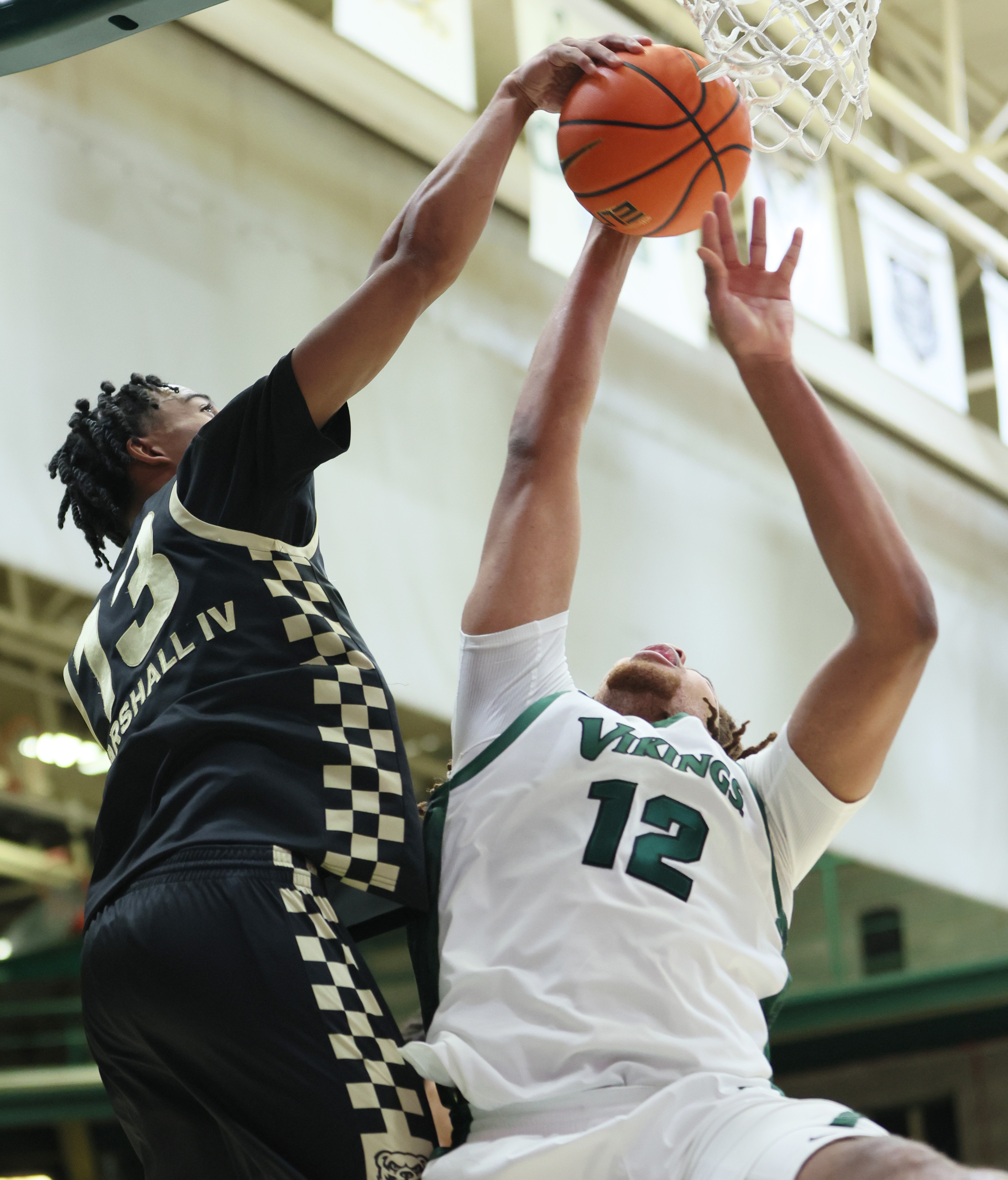 Cleveland State Vikings forward Holden Pierre-Louis (12) has his shot attempt blocked by Oakland Golden Grizzlies guard Warren Marshall IV in the first half.