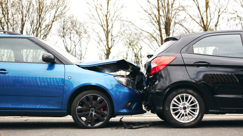 a blue car that has rear ended a black car