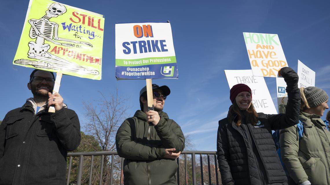 Striking health care workers wave signs outside Kaiser Permanente’s Roseville Medical Center on Jan. 26 in Roseville as part of a monthlong labor walkout. The union later Monday that workers would return Tuesday after reporting “significant movement” in contract talks with Kaiser.