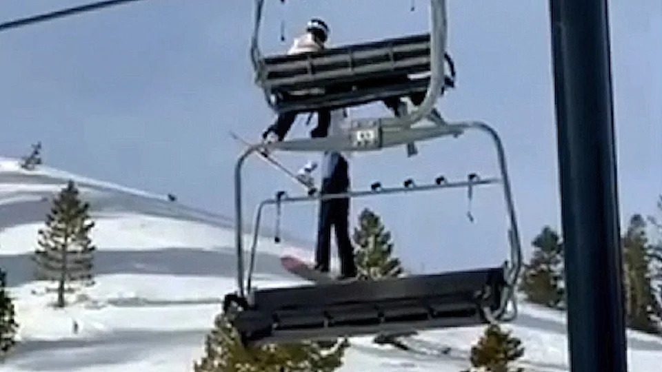 Girl dangles from ski lift high above snowy slope at California resort