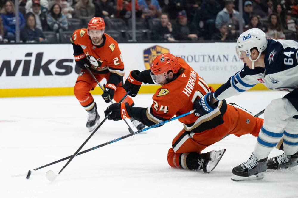 Kyusung Gong / The Associated Press
Anaheim Ducks’ Jansen Harkins, centre, and Winnipeg Jets defenceman Logan Stanley, right, vie for the puck during the first period, Friday, in Anaheim.