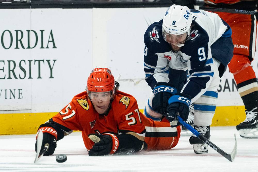 Kyusung Gong / The Associated Press
Anaheim Ducks defenceman Olen Zellweger, left, and Winnipeg Jets left wing Alex Iafallo battle for the puck during the second period.