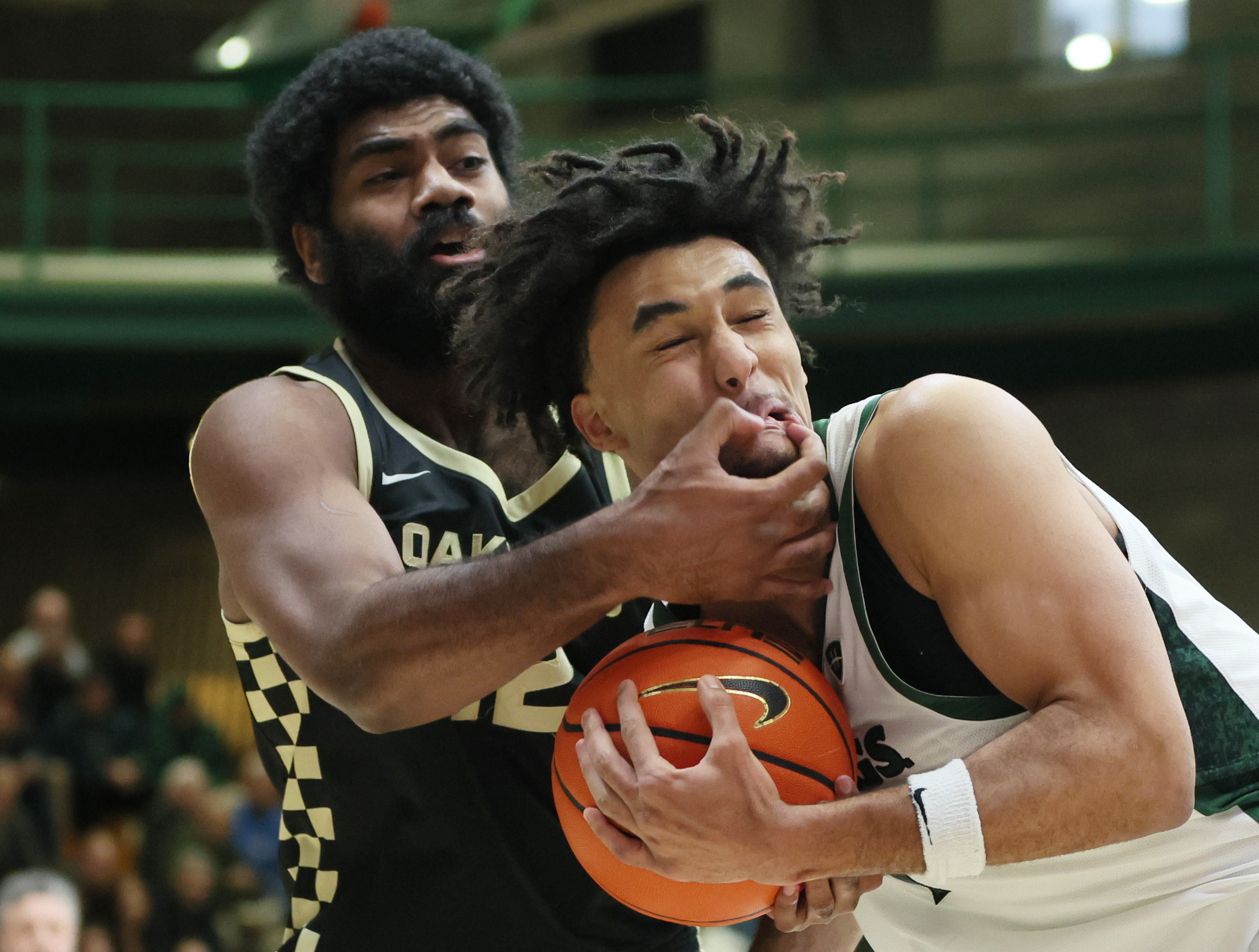 Cleveland State Vikings forward Dayan Nessah has his face inadvertently grabbed by Oakland Golden Grizzlies forward Tuburu Naivalurua on Nessah’s drive to the basket in the first half.