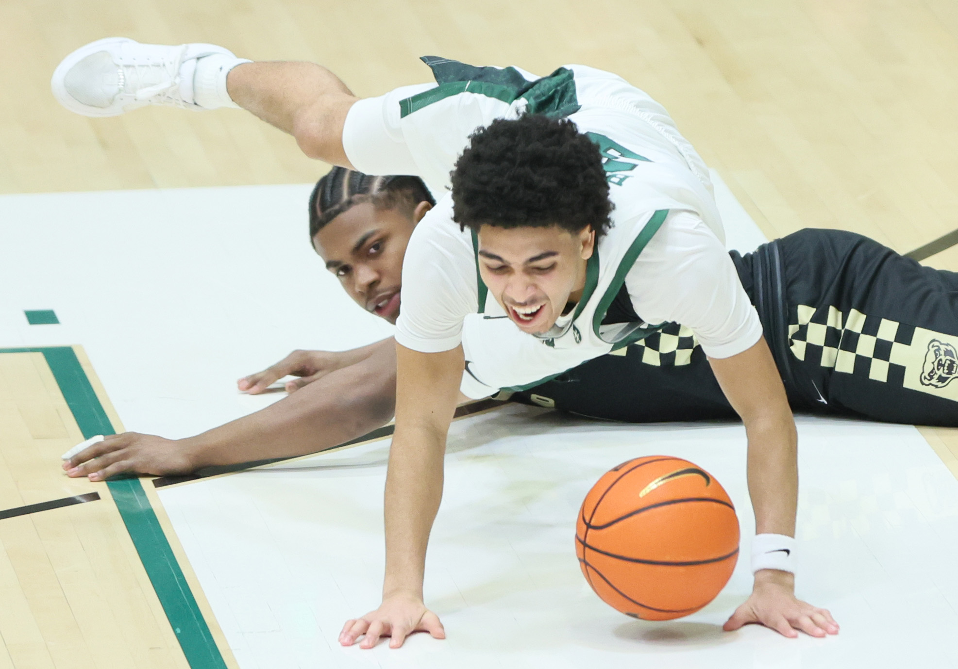 Cleveland State Vikings guard Tre Beard falls to the floor after a diving steal attempt by Oakland Golden Grizzlies guard Khoi Thurmon tripped Beard in the second half.  