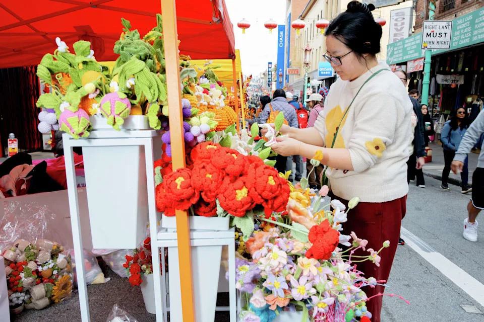 Ling Rao attends the Chinese New Year Flower Market Fair in San Francisco's Chinatown on Saturday. (Jonah Reenders/For the S.F. Chronicle)