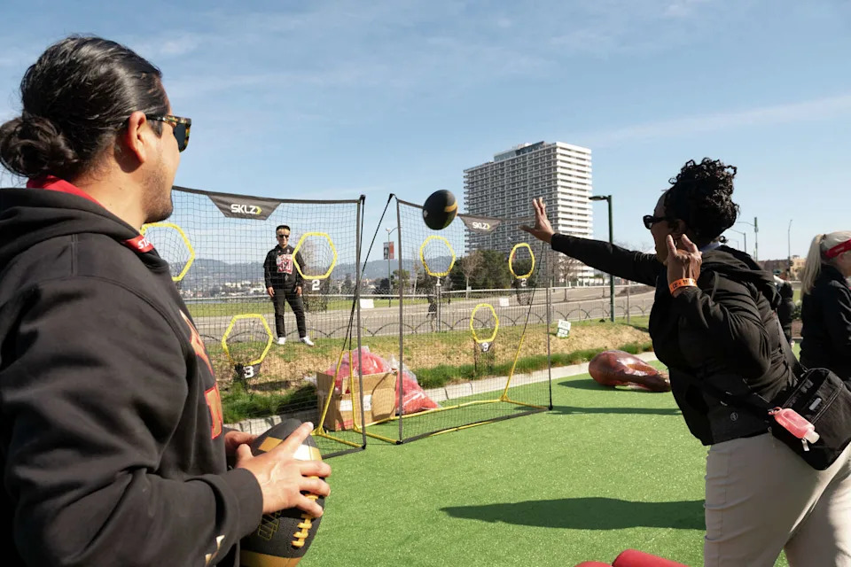 People play lawn games ahead of the game during a Super Bowl fan zone and watch party at the Henry J. Kaiser Center for the Arts in Oakland on Sunday. (Laure Andrillon/For the S.F. Chronicle)
