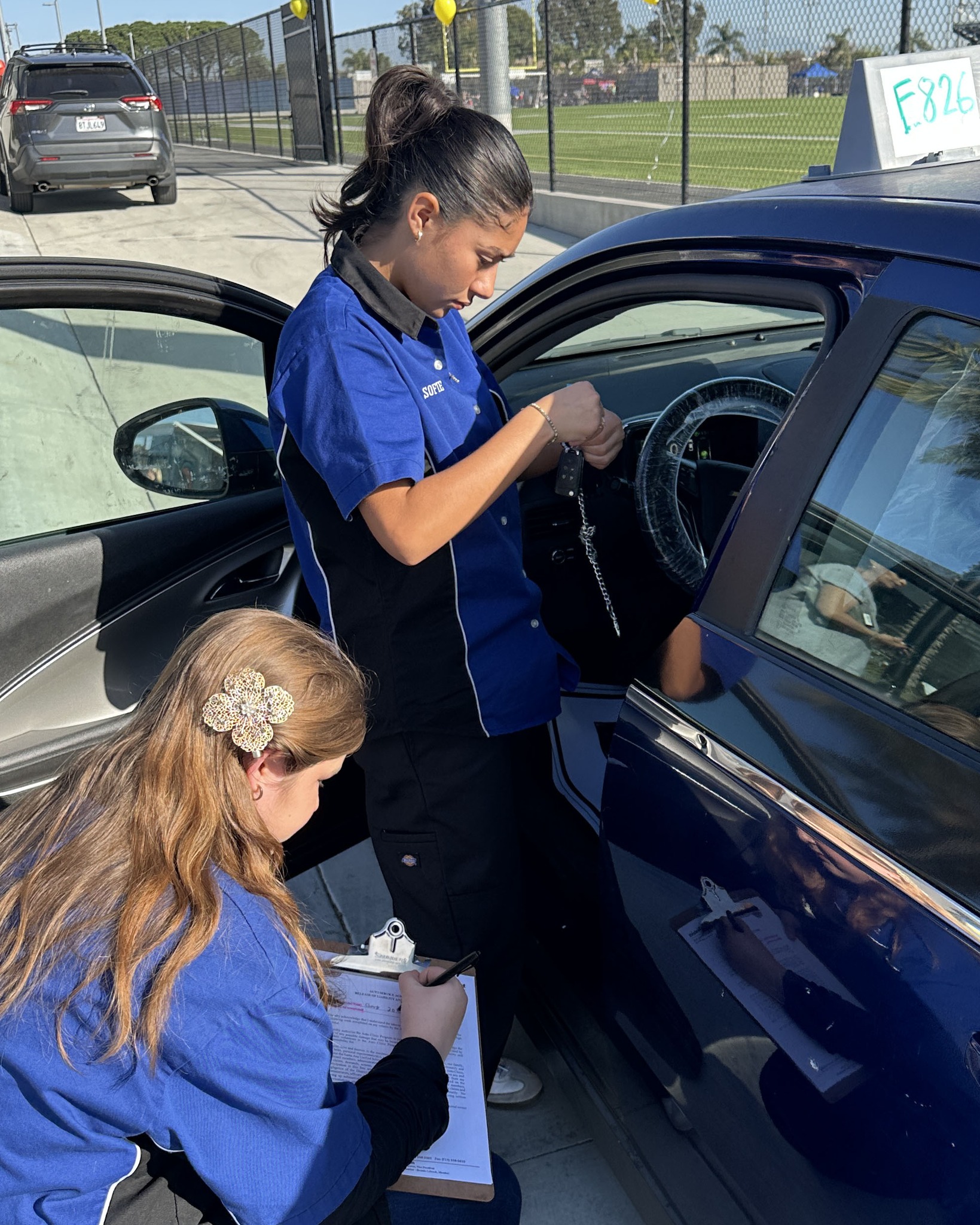 Automotive students complete the intake process for a vehicle before it enters the service bay during the Community Garage clinic at Valley High School.