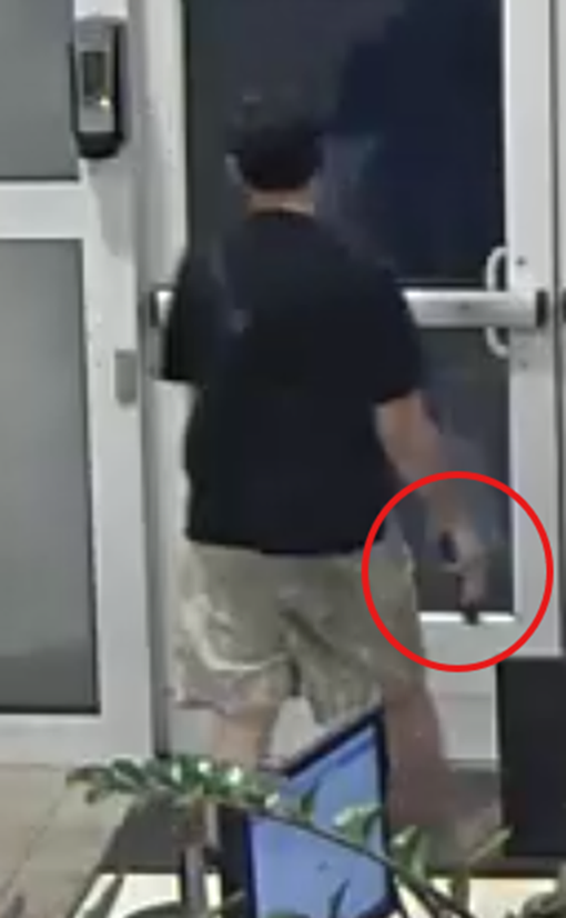 Surveillance photo of suspect with gun