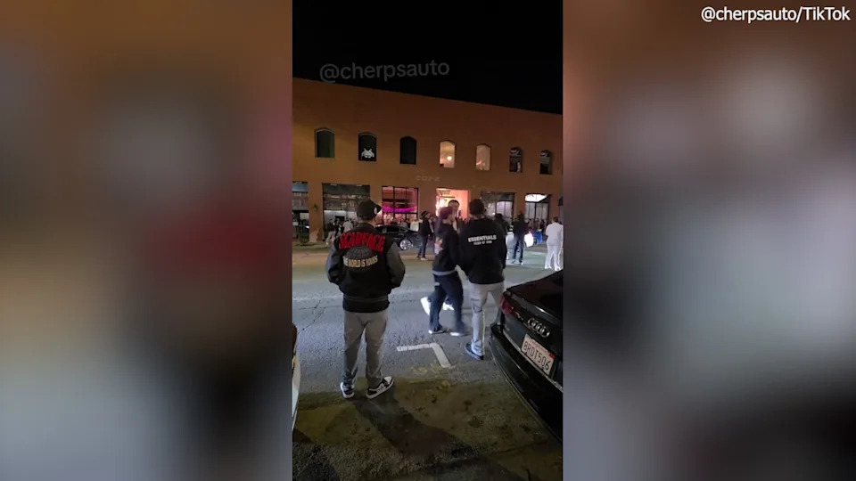people gathering outside bar into street