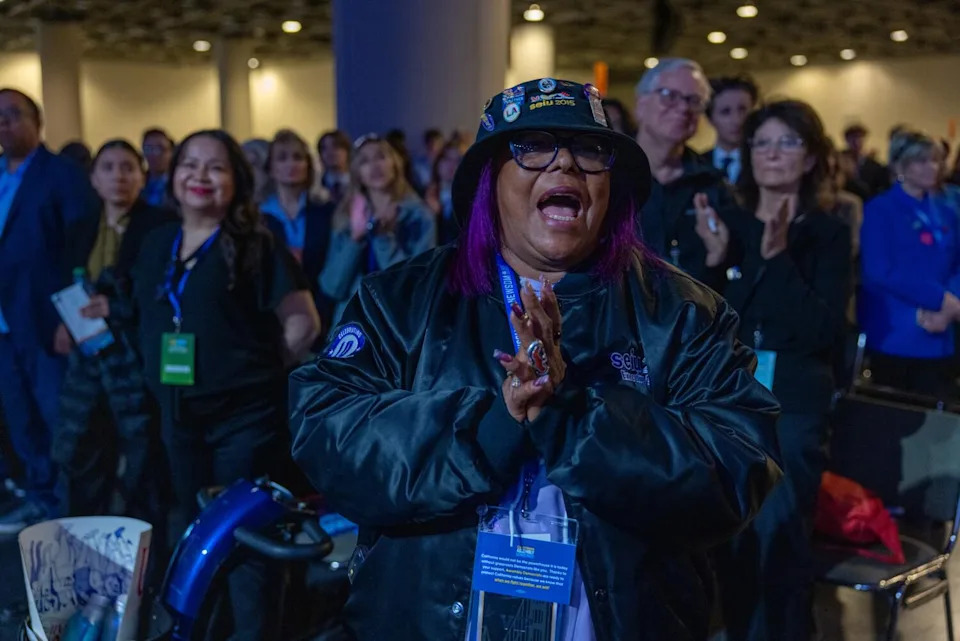 A woman enthusiastically cheers at state Democratic Party convention