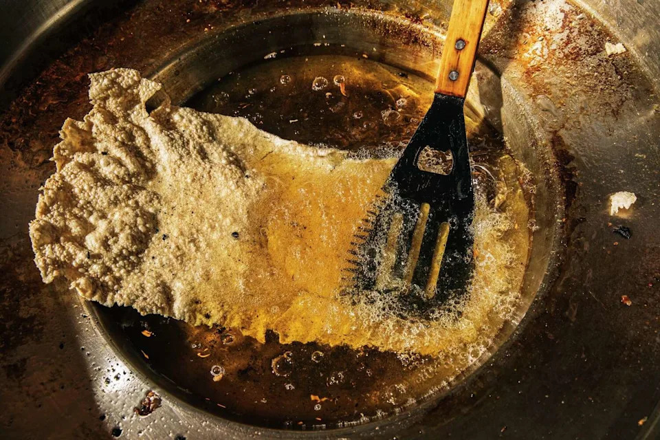 A tostada fried in oil at Cenaduria Elvira in Oakland in 2022. (Stephen Lam/The Chronicle)