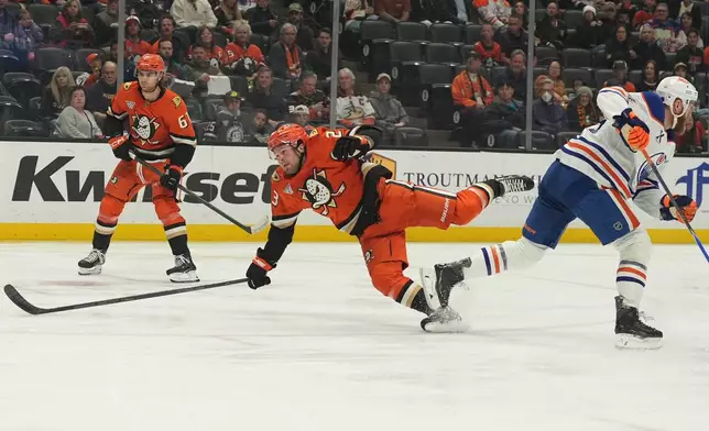 Anaheim Ducks center Mason McTavish, left, falls after colliding with Edmonton Oilers defenseman Mattias Ekholm, right, during the first period of an NHL hockey game Wednesday, Feb. 25, 2026, in Anaheim, Calif. (AP Photo/Gregory Bull)