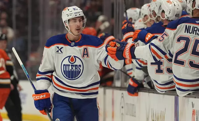 Edmonton Oilers center Ryan Nugent-Hopkins, left, celebrates his goal with teammates during the first period of an NHL hockey game against the Anaheim Ducks Wednesday, Feb. 25, 2026, in Anaheim, Calif. (AP Photo/Gregory Bull)