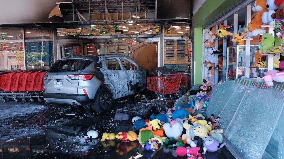 A charred vehicle sits at a damaged supermarket in Guadalajara, Jalisco state, Mexico, Sunday, Feb. 22, 2026, after the death of the leader of the Jalisco New Generation Cartel, Nemesio Rubén Oseguera Cervantes, known as "El Mencho." (AP Photo/Alejandra Leyva)